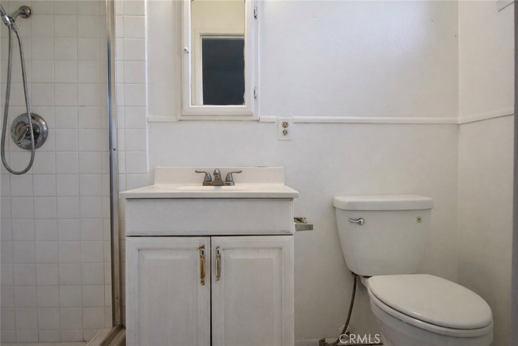 7251 Middlesex Drive Stanton, CA 90680 - Photo 9 of 11 a bathroom with a toilet a sink and a shower