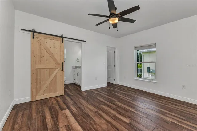 a kitchen with a refrigerator and white cabinets