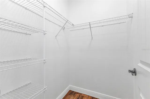 a kitchen with granite countertop a sink a stove and cabinets