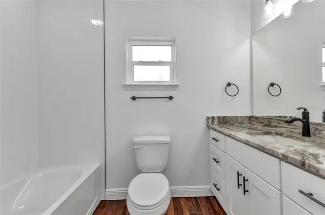 a kitchen with kitchen island granite countertop a stove sink and cabinets