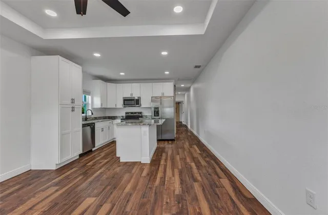 a bathroom with a granite countertop toilet a sink and bathtub