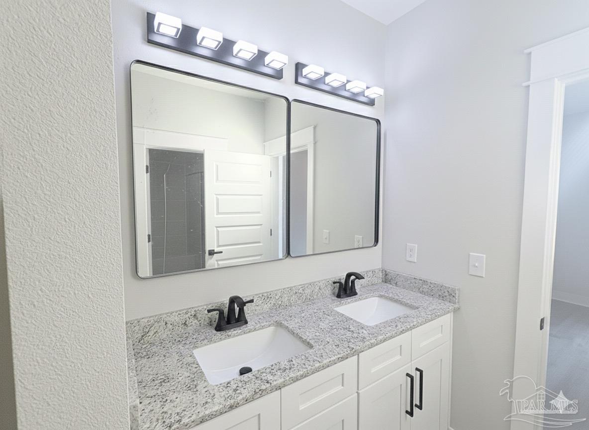 2936 North 14th Avenue Milton, FL 32583 - Photo 13 of 23 a bathroom with a granite countertop sink and a mirror