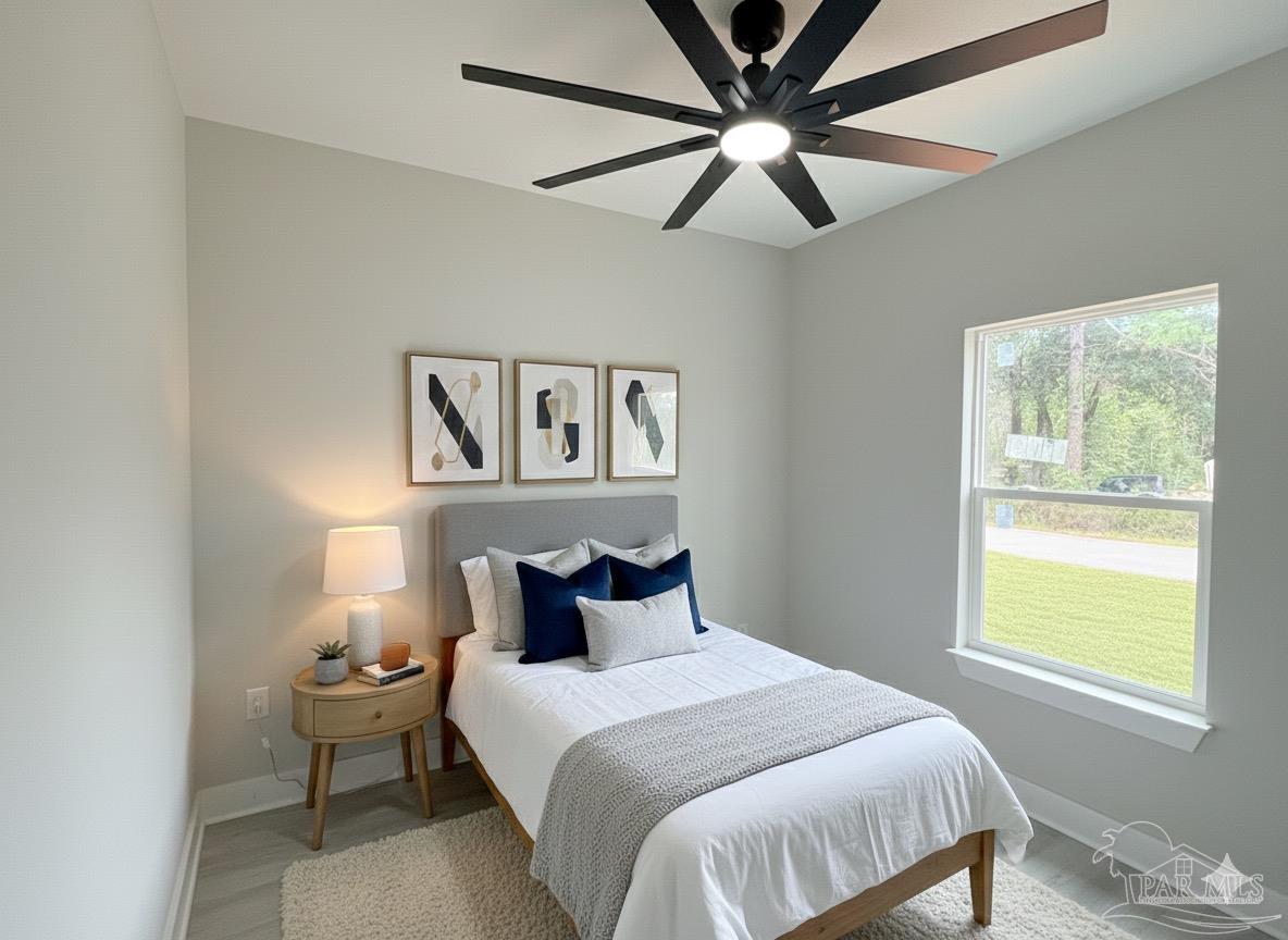 2936 North 14th Avenue Milton, FL 32583 - Photo 15 of 23 a bedroom with a bed and window