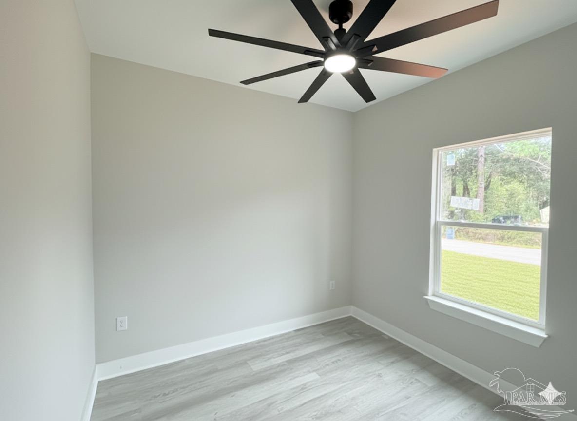2936 North 14th Avenue Milton, FL 32583 - Photo 16 of 23 an empty room with a window and a fan
