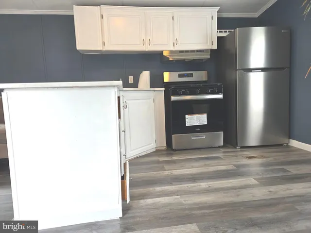 a kitchen with a refrigerator and window