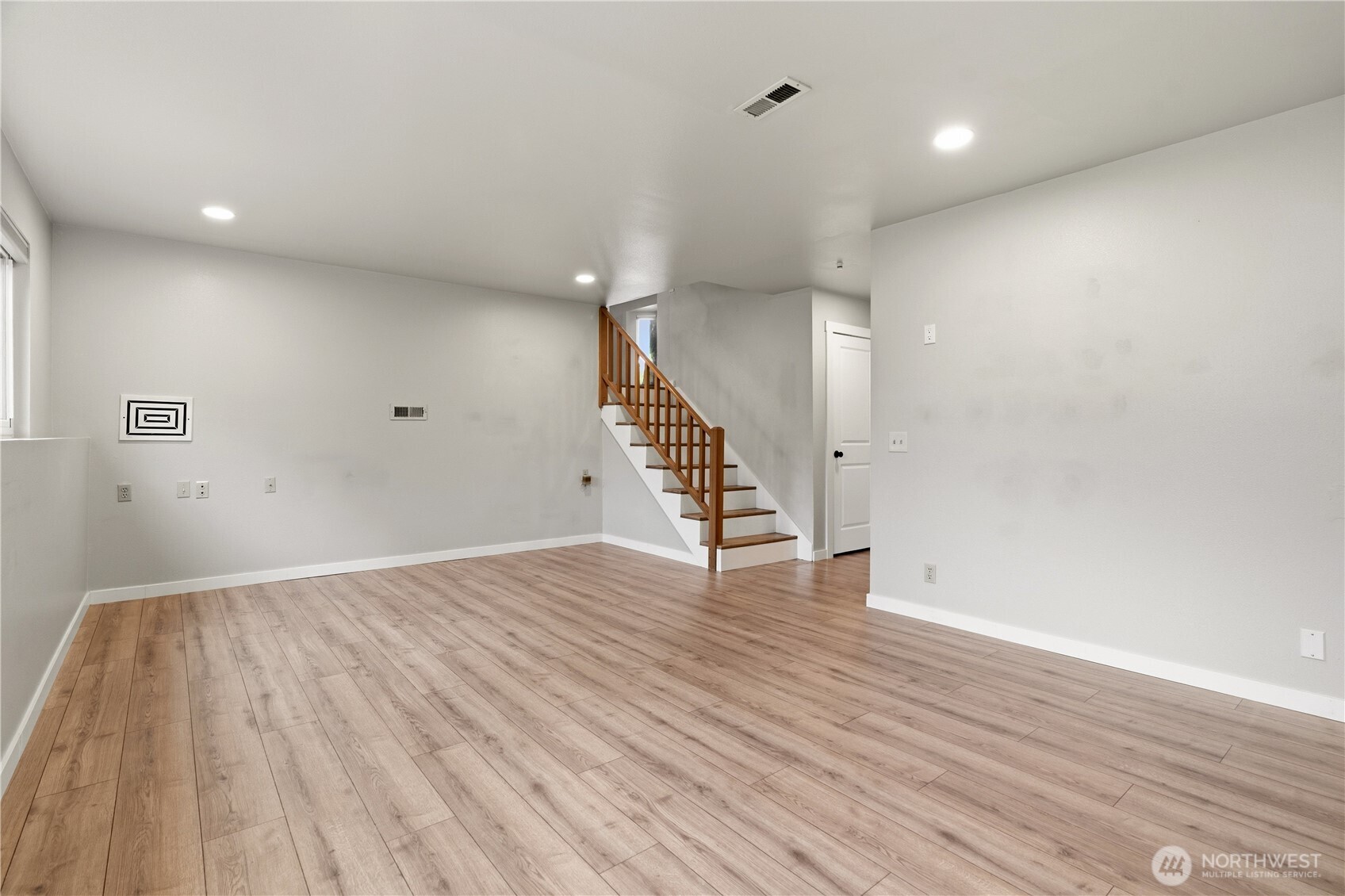 2401 185th Place Southeast Bothell, WA 98012 - Photo 12 of 36 an empty room with wooden floor and staircase