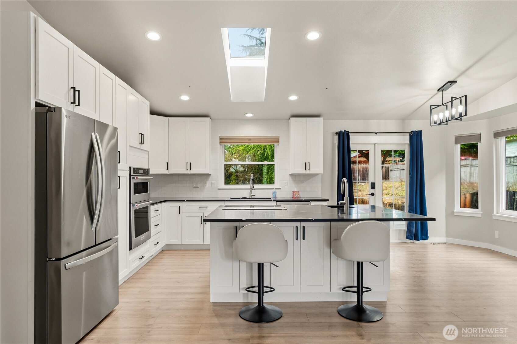 2401 185th Place Southeast Bothell, WA 98012 - Photo 17 of 36 a kitchen with stainless steel appliances granite countertop a refrigerator and a sink