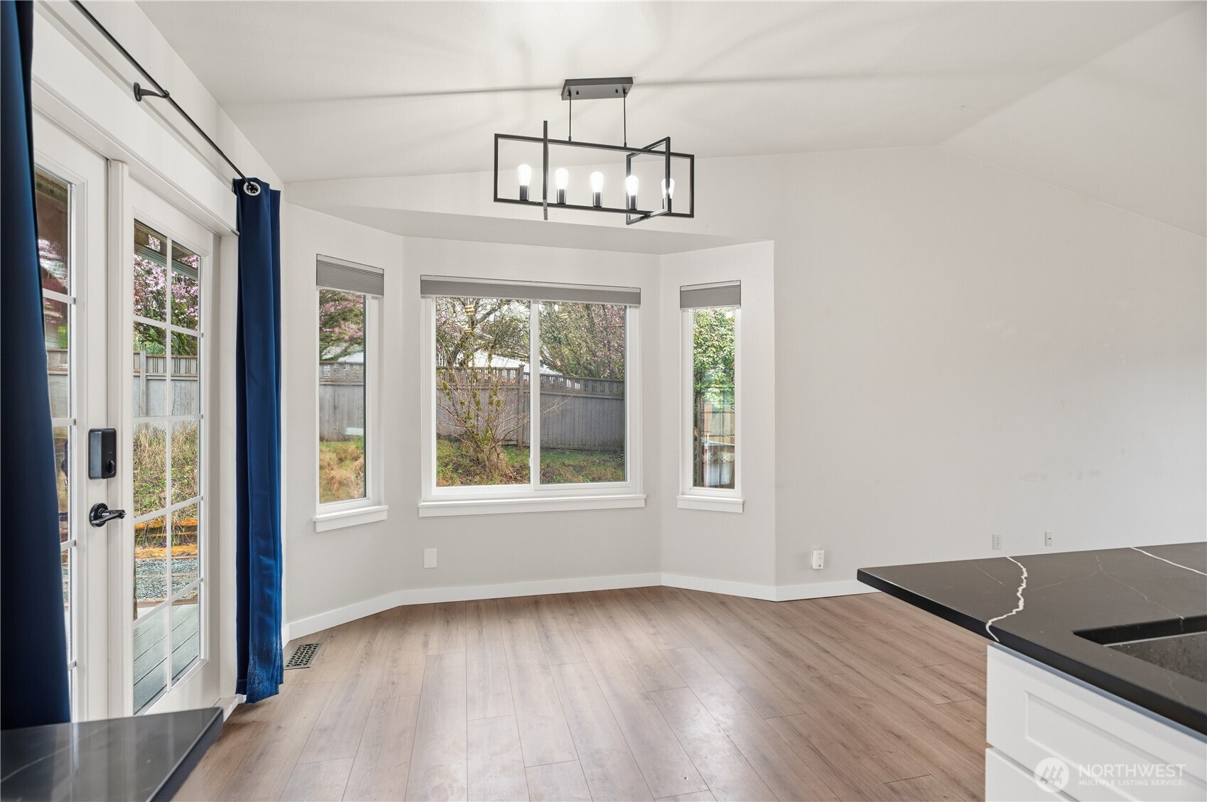 2401 185th Place Southeast Bothell, WA 98012 - Photo 19 of 36 an empty room with wooden floor fan and windows
