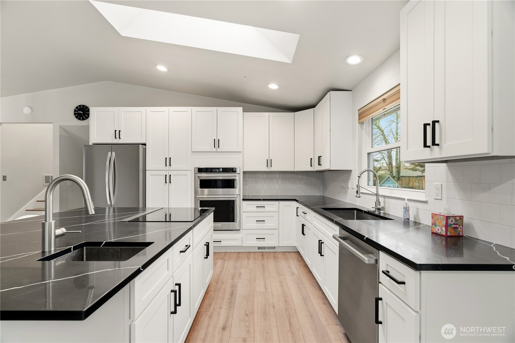 2401 185th Place Southeast Bothell, WA 98012 - Photo 20 of 36 a kitchen with kitchen island granite countertop a sink stainless steel appliances and cabinets
