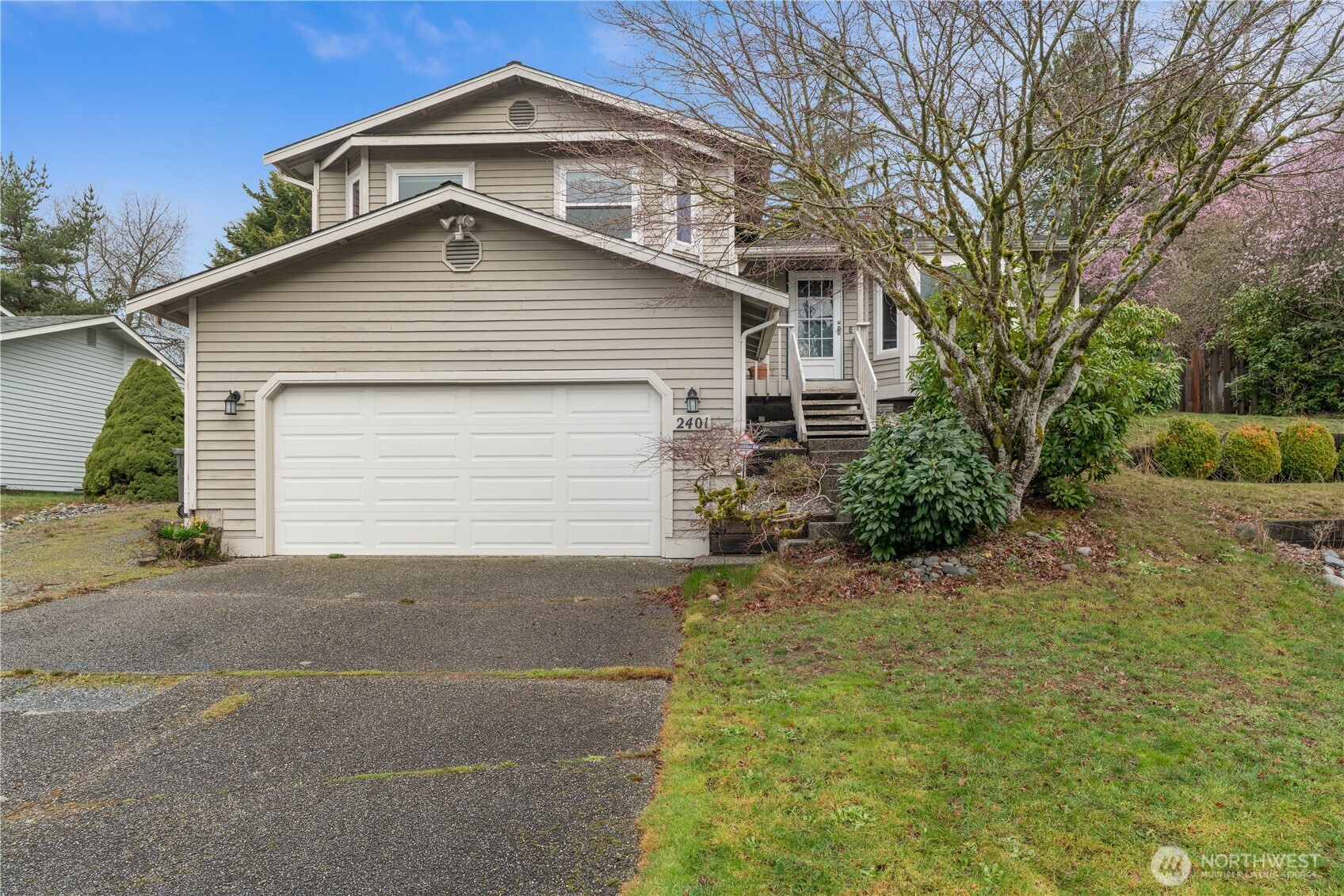 2401 185th Place Southeast Bothell, WA 98012 - Photo 2 of 36 a front view of a house with a yard and garage