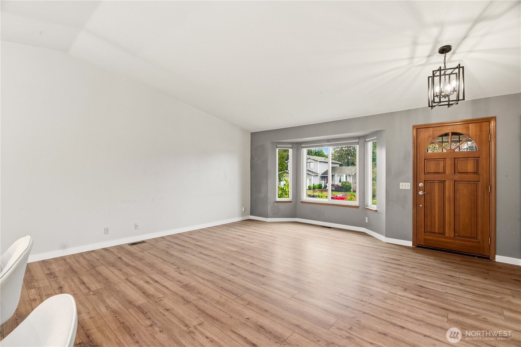2401 185th Place Southeast Bothell, WA 98012 - Photo 23 of 36 a view of an empty room with wooden floor and fan