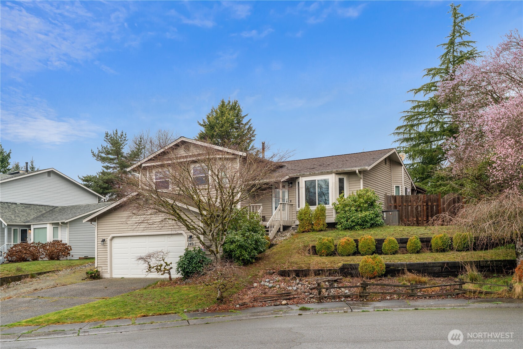 2401 185th Place Southeast Bothell, WA 98012 - Photo 3 of 36 a front view of a house with a yard