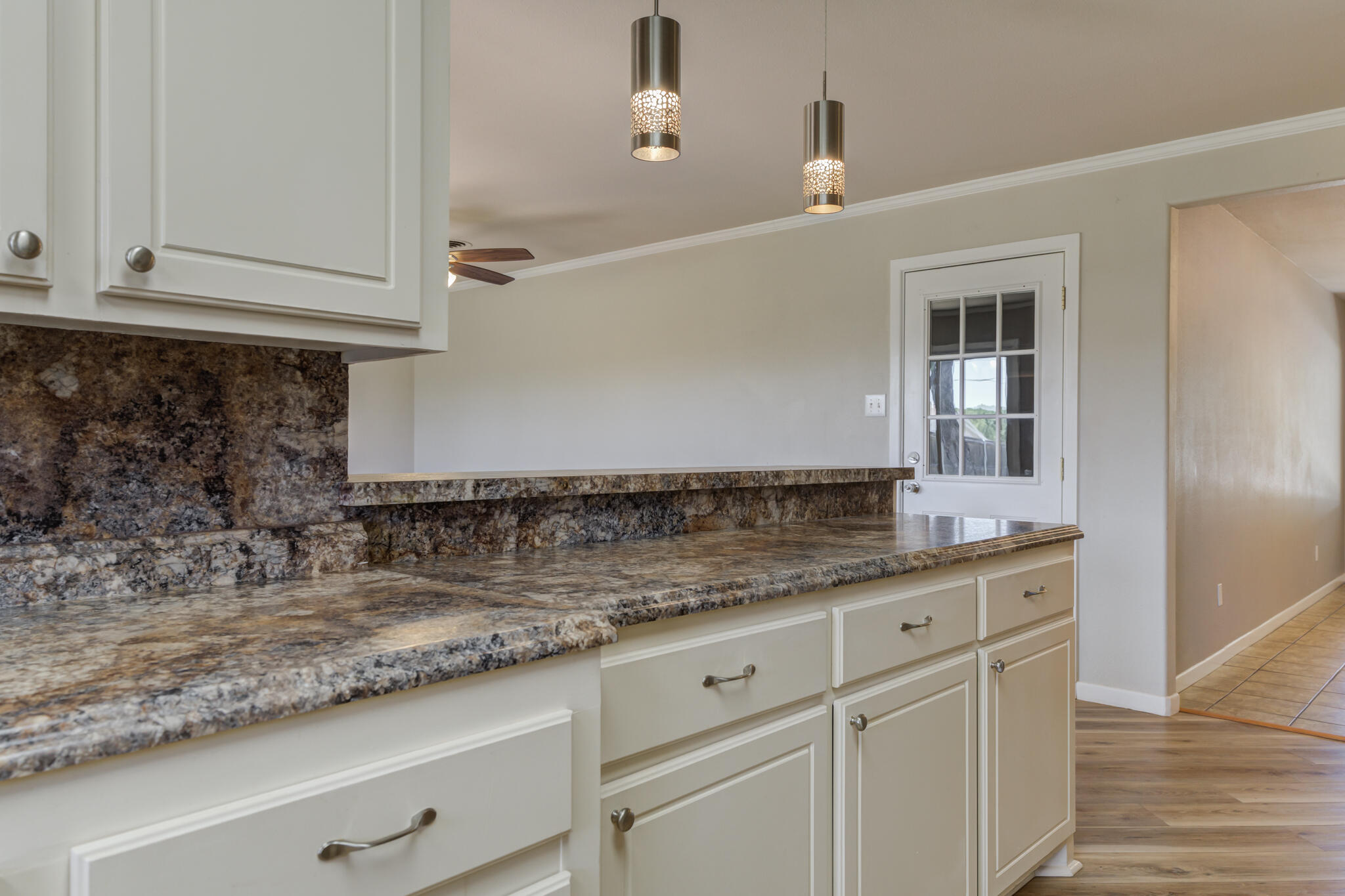 4921 10th Street Lubbock, TX 79416 - Photo 11 of 29 a kitchen with granite countertop a sink and cabinets