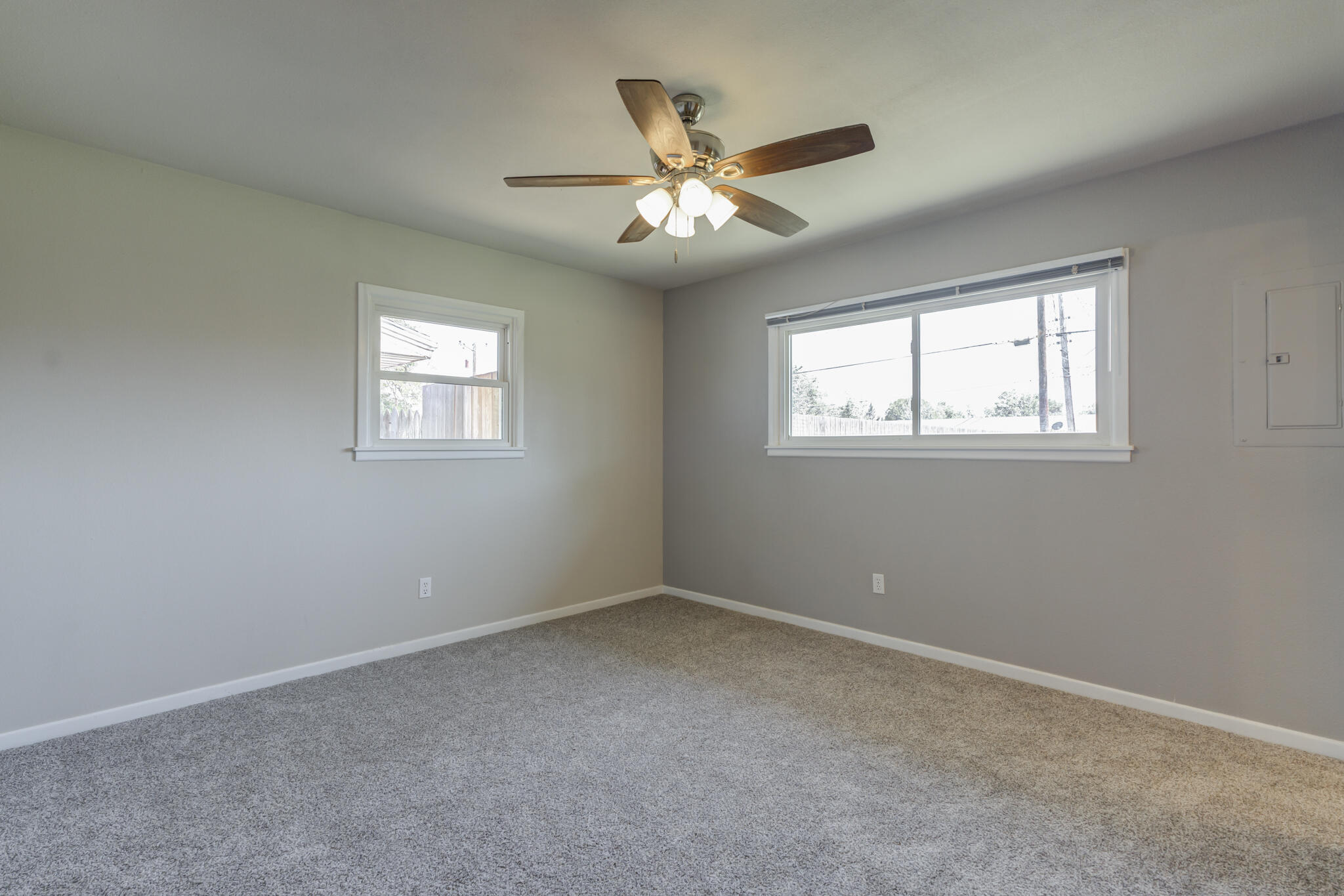 4921 10th Street Lubbock, TX 79416 - Photo 15 of 29 an empty room with windows and fan