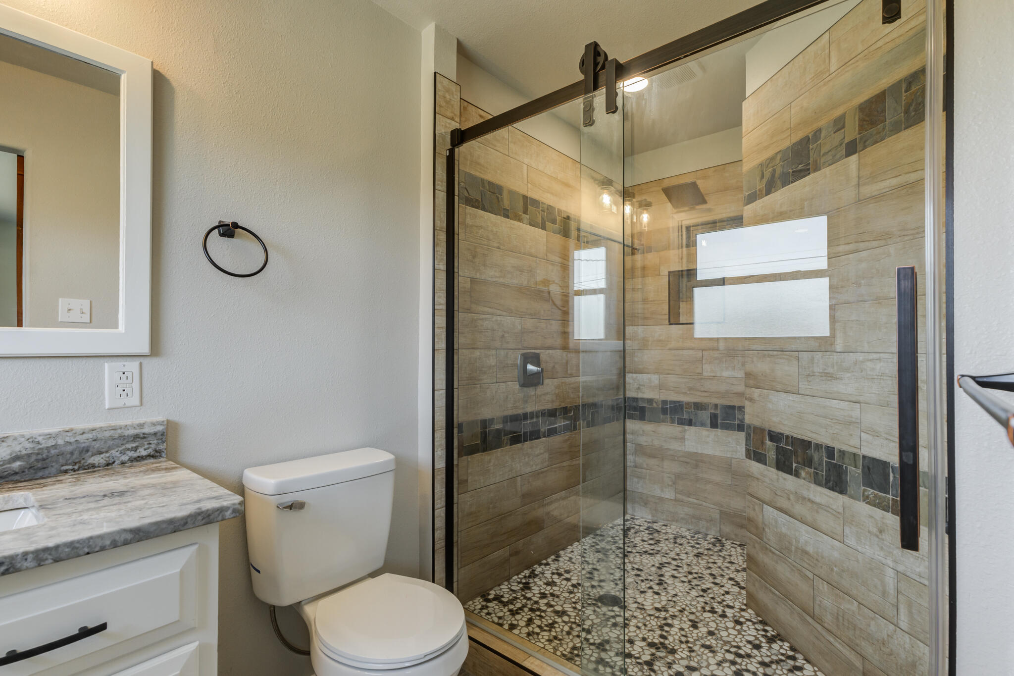 4921 10th Street Lubbock, TX 79416 - Photo 18 of 29 a bathroom with a shower a toilet and a sink