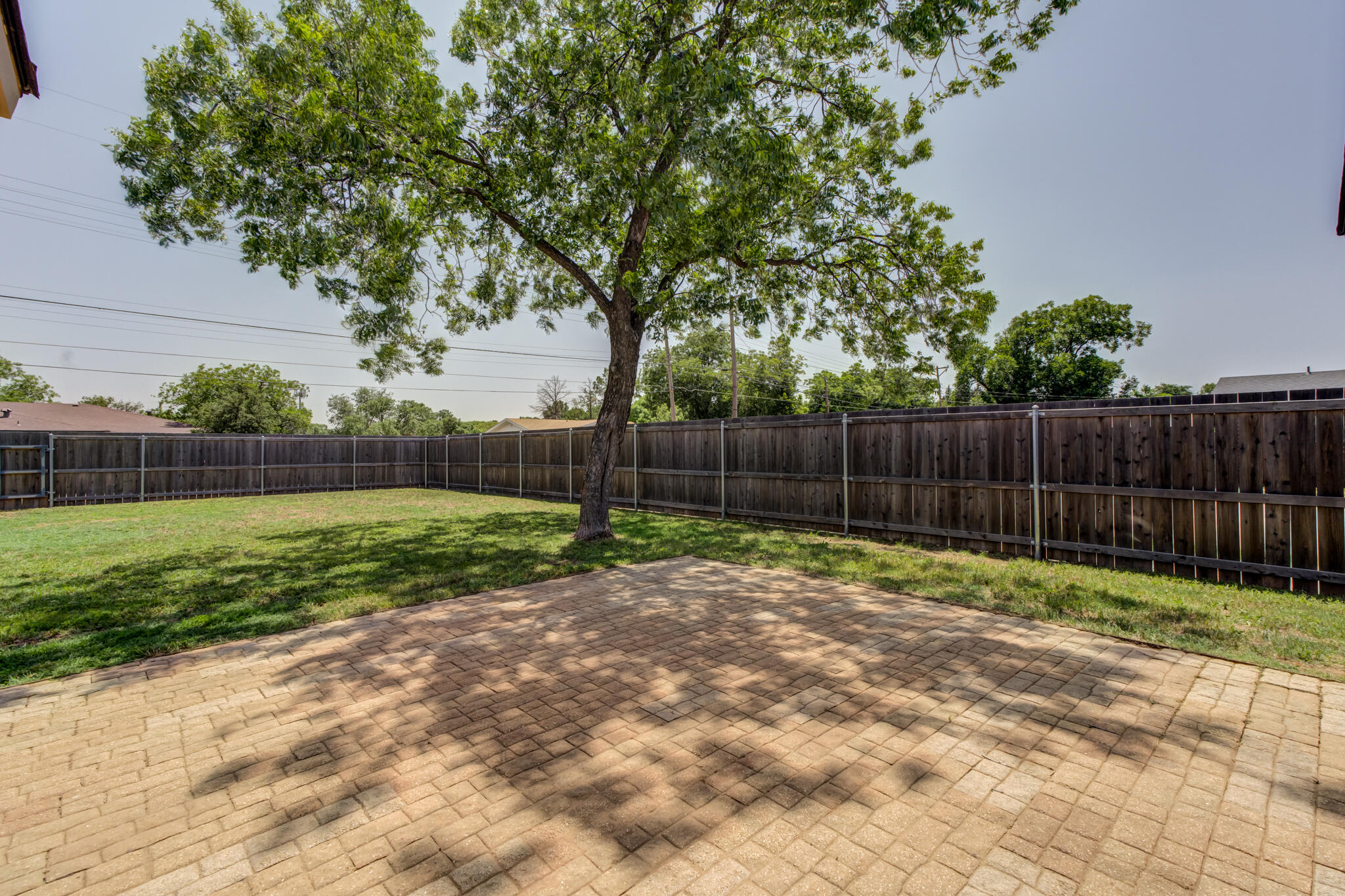 4921 10th Street Lubbock, TX 79416 - Photo 25 of 29 a view of a backyard with wooden fence