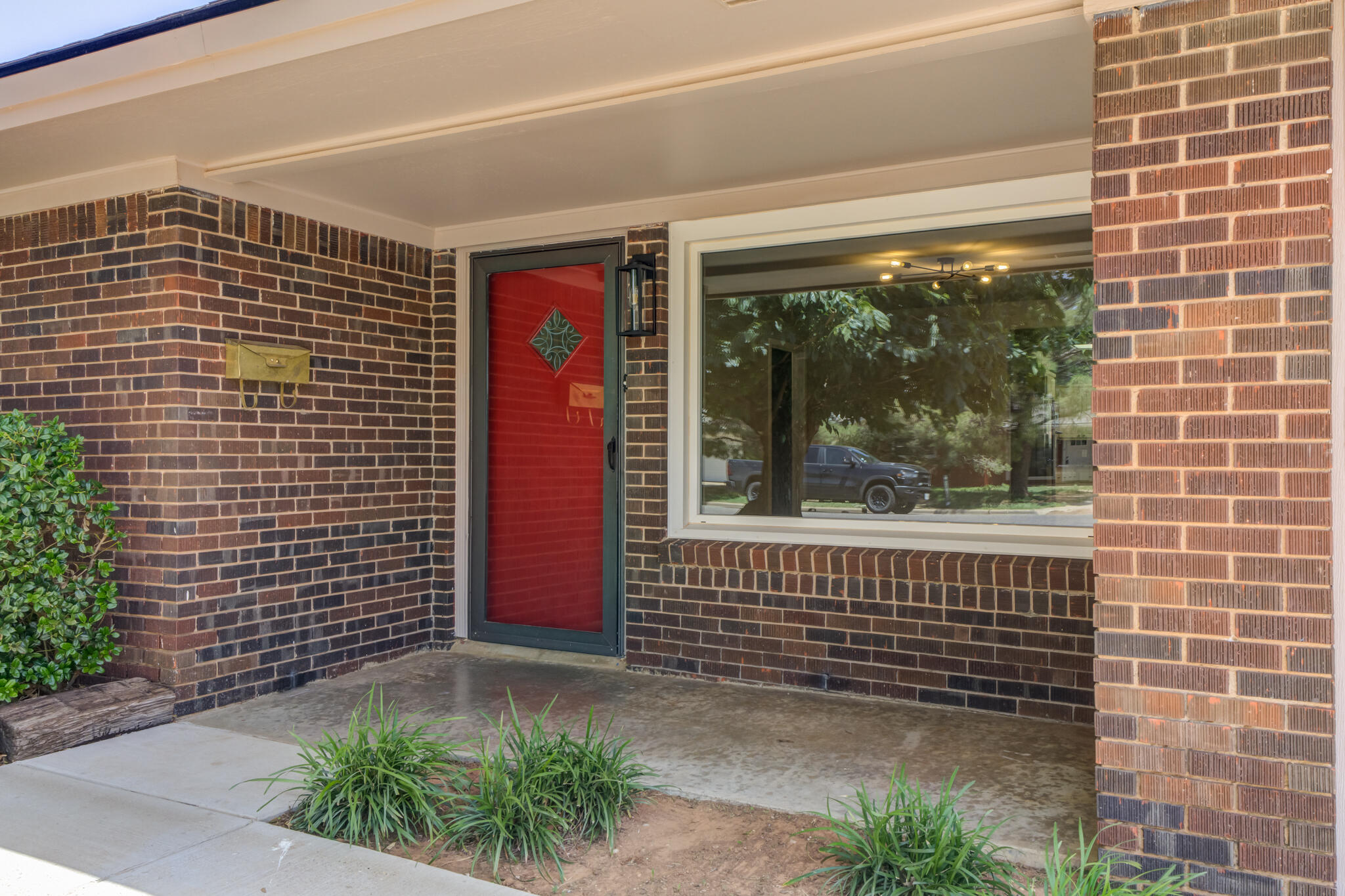 4921 10th Street Lubbock, TX 79416 - Photo 3 of 29 a front view of a house with a yard