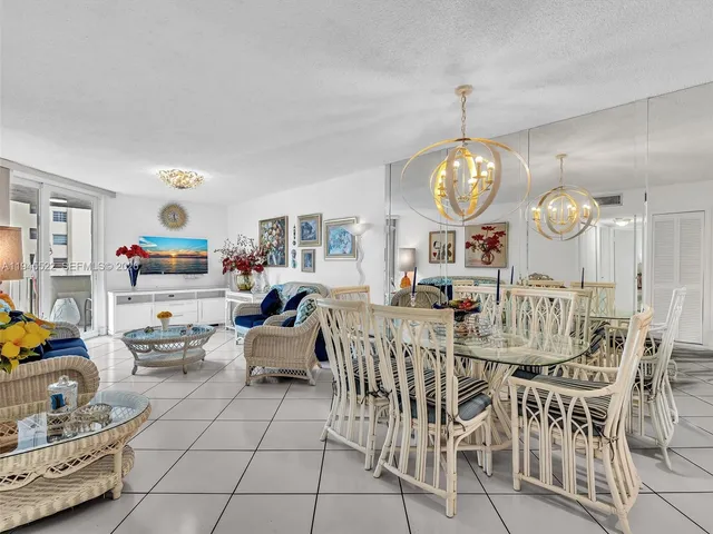 a living room with furniture and painting on the wall