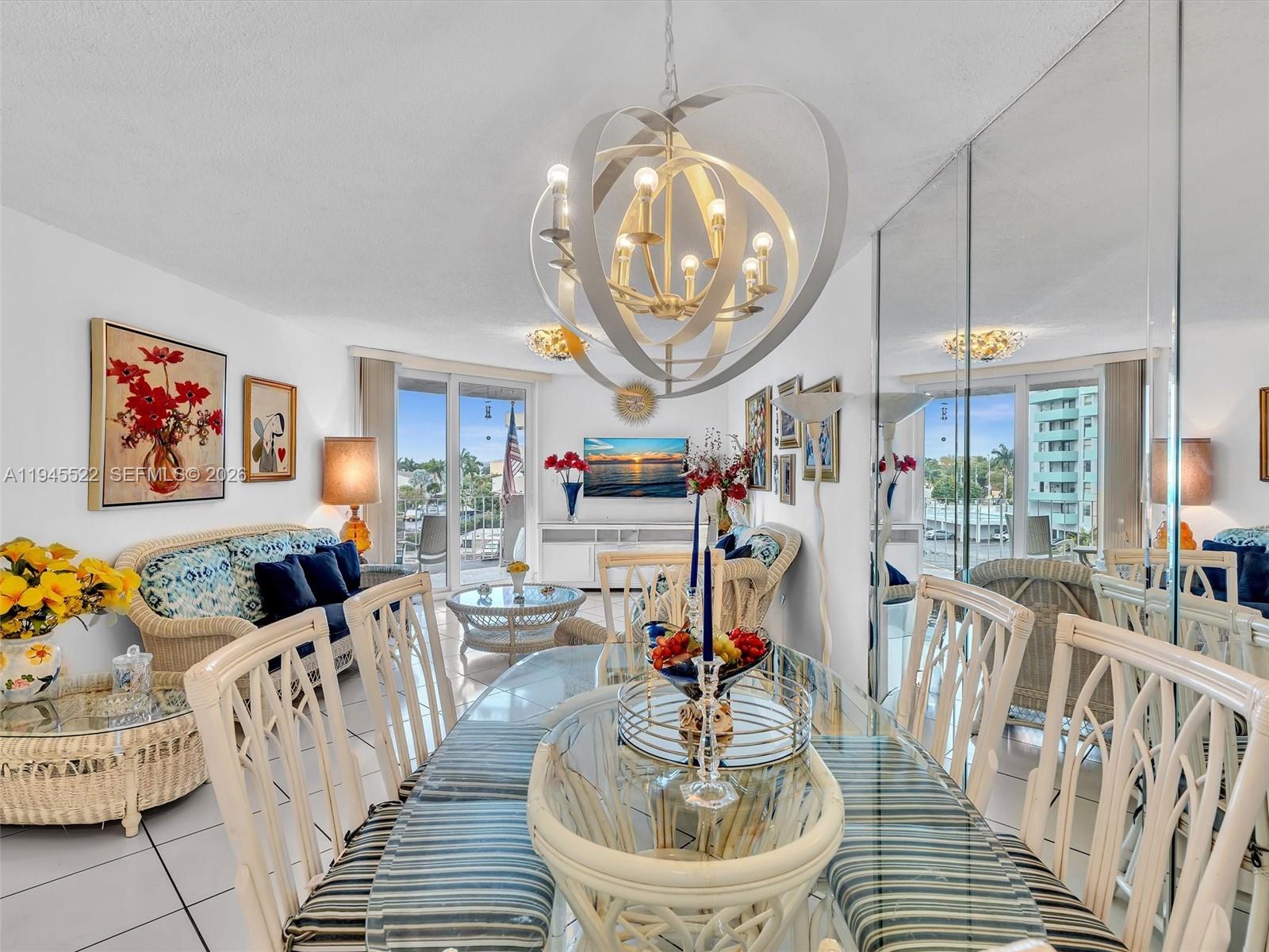 1750 West 46th Street, Unit 404 Hialeah, FL 33012 - Photo 17 of 42 a living room with furniture a fireplace and a chandelier