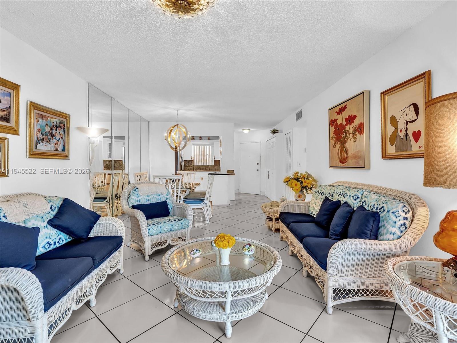 1750 West 46th Street, Unit 404 Hialeah, FL 33012 - Photo 20 of 42 a living room with furniture and a wooden floor