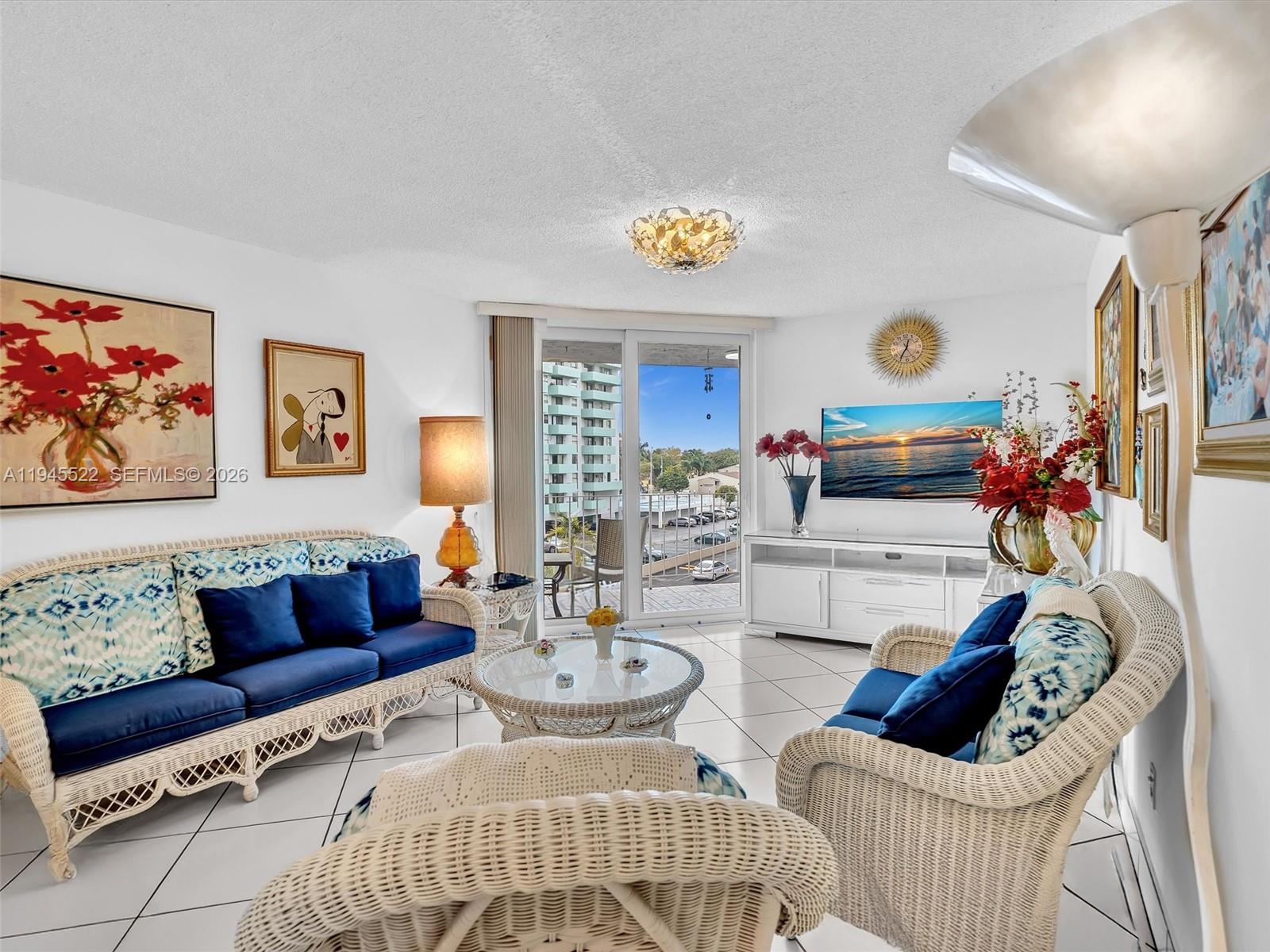 1750 West 46th Street, Unit 404 Hialeah, FL 33012 - Photo 21 of 42 a living room with furniture and painting on the wall