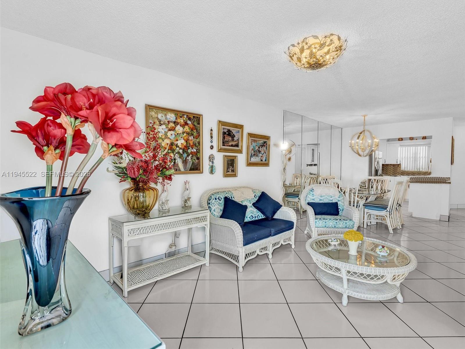 1750 West 46th Street, Unit 404 Hialeah, FL 33012 - Photo 23 of 42 a living room with furniture a dining table and a potted plant