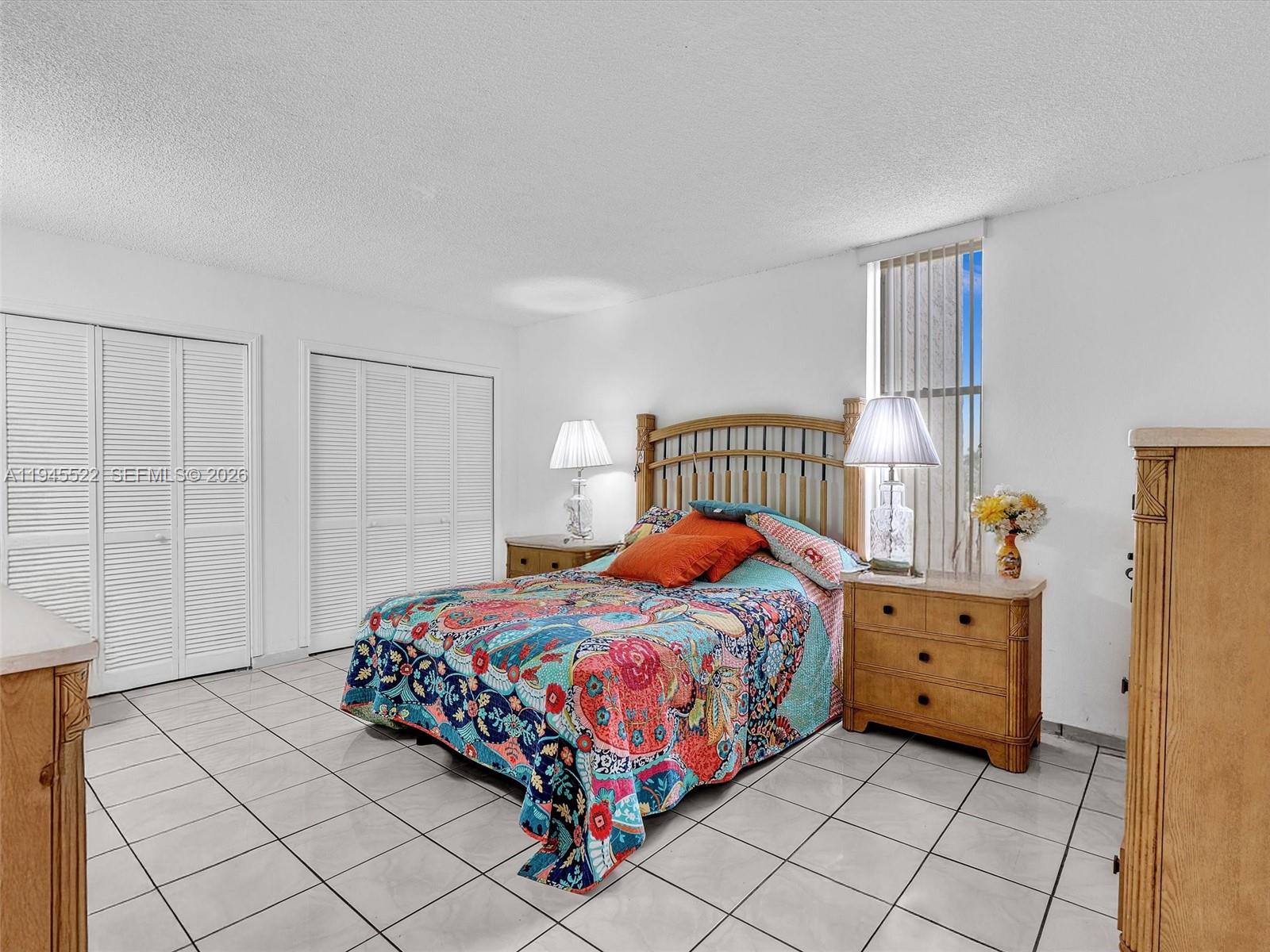 1750 West 46th Street, Unit 404 Hialeah, FL 33012 - Photo 25 of 42 a bedroom with a bed and a window