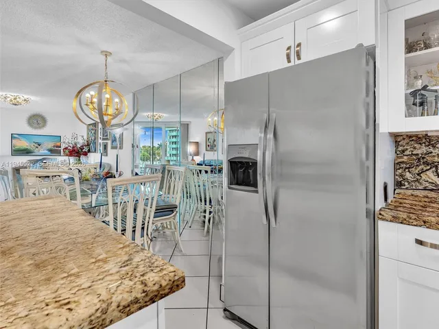 a kitchen with white cabinets sink and appliances