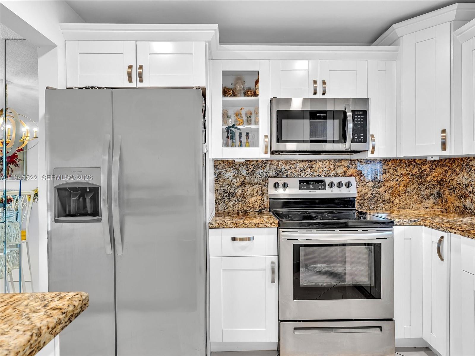 1750 West 46th Street, Unit 404 Hialeah, FL 33012 - Photo 8 of 42 a kitchen with stainless steel appliances granite countertop a refrigerator a stove and a sink