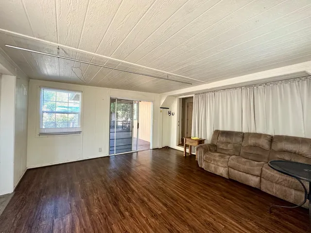 a living room with couches and a coffee table with wooden floor