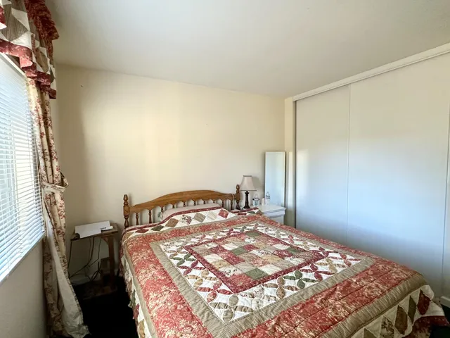 a bedroom with a bed and a window