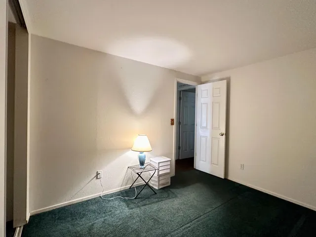 a living room with furniture and a lamp