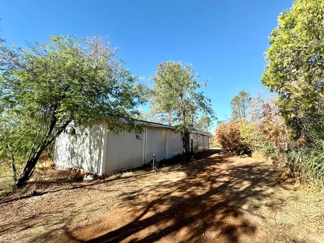 a view of a wooden house with a yard