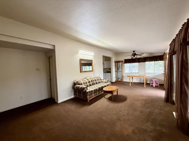 a bedroom with furniture and a large window