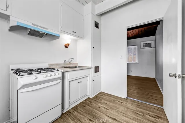 a kitchen with white cabinets and white appliances