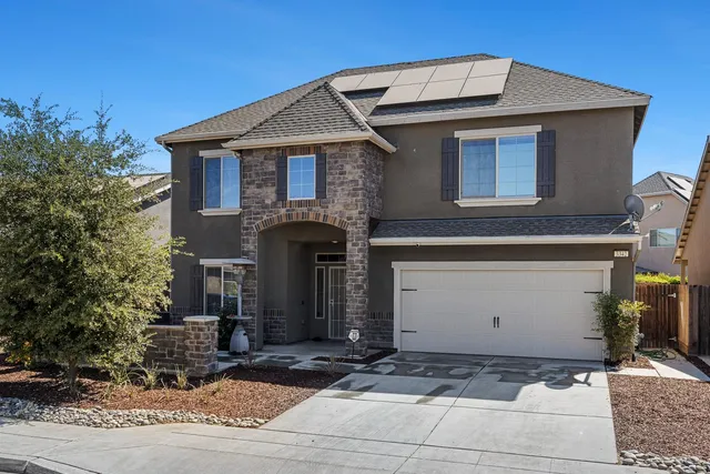 a front view of a house with garage