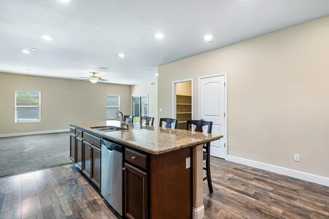 a living room with furniture a flat screen tv and a window
