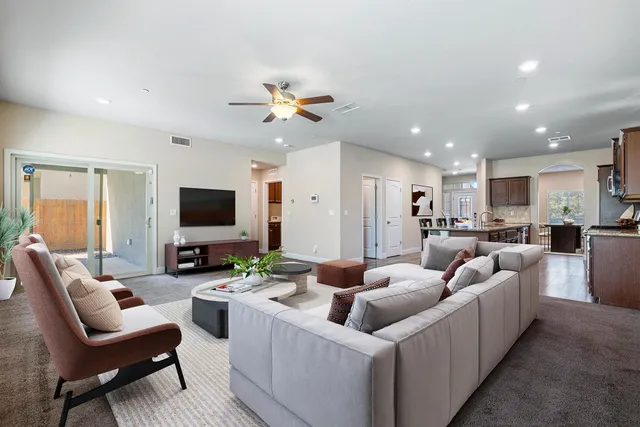 a bathroom with a granite countertop toilet sink mirror and vanity