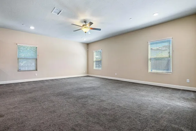 an empty room with windows and closet