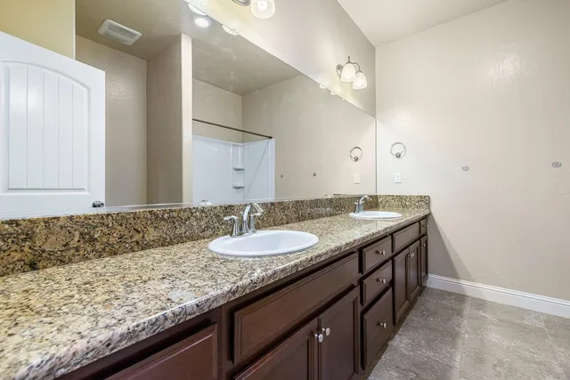 an empty room with chandelier fan