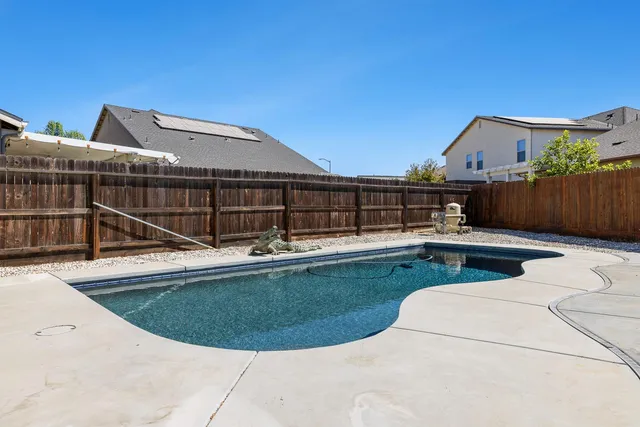 a view of a swimming pool with lounge chair