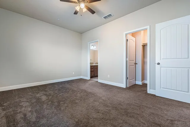 a bedroom with furniture and a large mirror