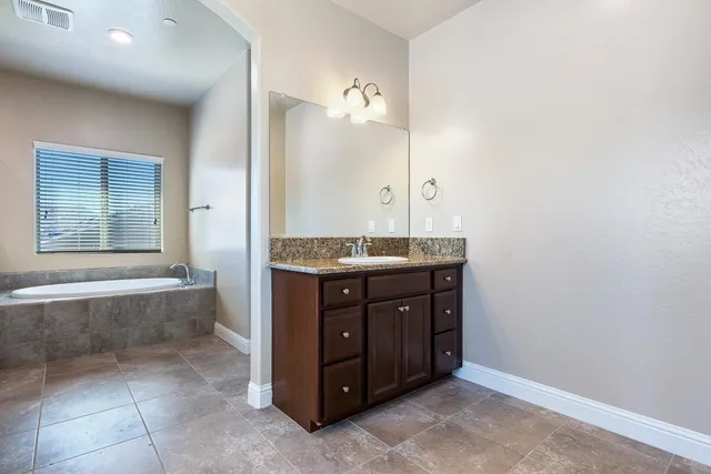 a view of a house with wooden fence