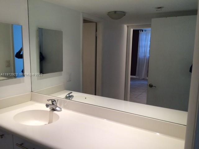680 Northeast 64th Street, Unit A215 Miami, FL 33138 - Photo 20 of 24 a bathroom with a sink and a mirror