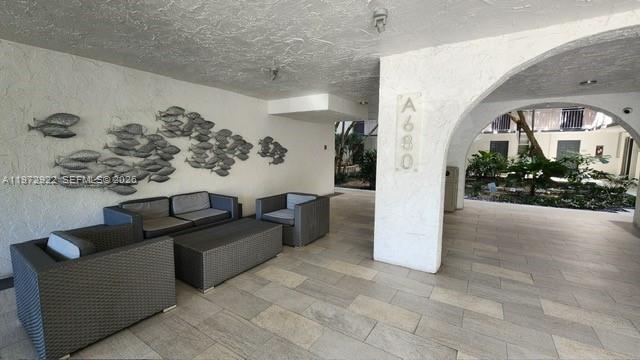 680 Northeast 64th Street, Unit A215 Miami, FL 33138 - Photo 4 of 24 a view of livingroom with furniture and a chandelier