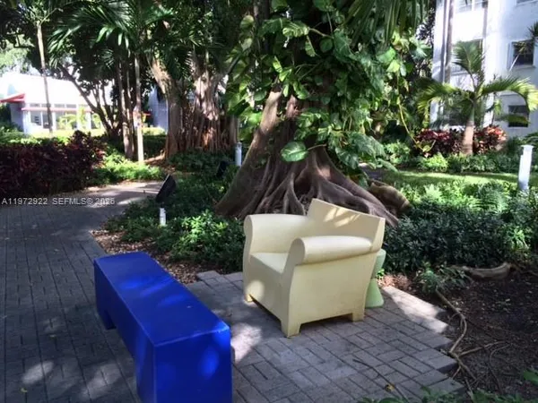 a view of a palm plant that is in front of a building