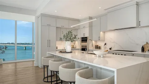 a kitchen with a sink cabinets and wooden floor