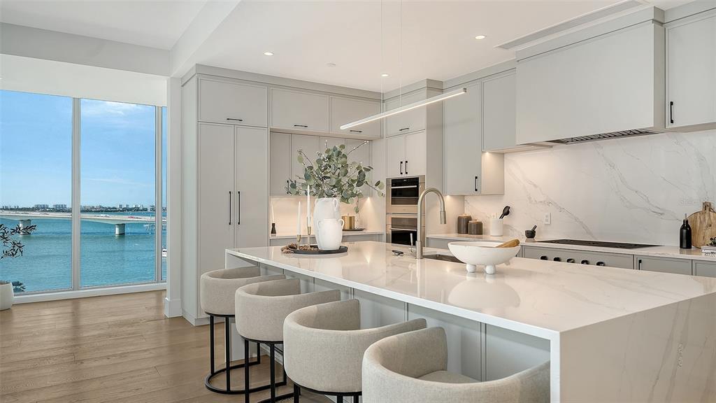 253 Golden Gate Point, Unit 703 Sarasota, FL 34236 - Photo 11 of 51 a kitchen with a sink cabinets and wooden floor