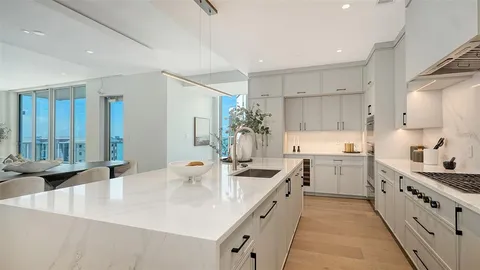 a kitchen with counter top space sink stove and cabinets