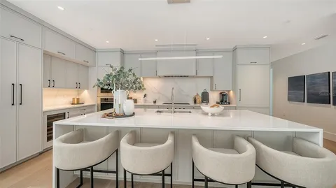 a kitchen with kitchen island granite countertop a table and chairs